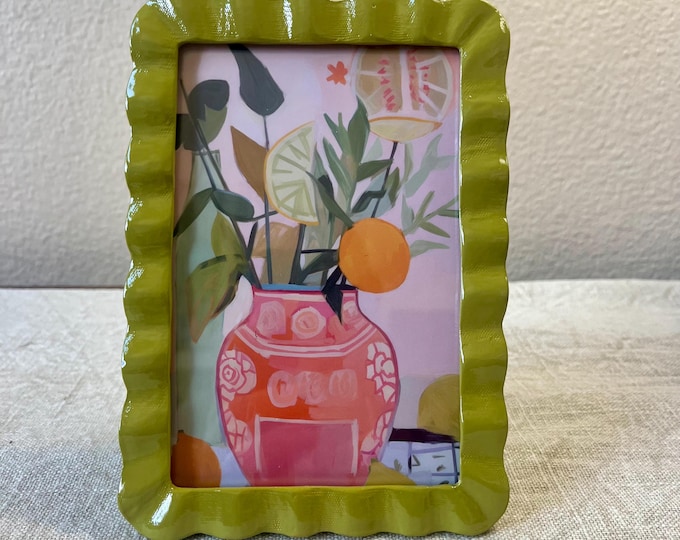 Vintage style olive green 6 3/4”x 4 3/4” resin frame holds a 3 1/2”x 5 1/2” photo