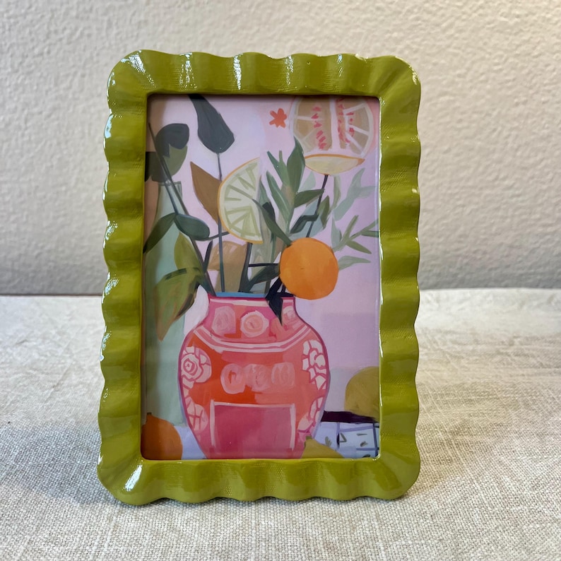 Vintage style olive green 6 3/4”x 4 3/4” resin frame holds a 3 1/2”x 5 1/2” photo
