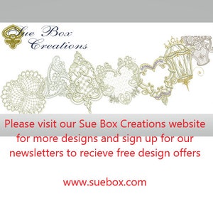 May include: Sue Box Creations logo with a decorative design of white lace hearts and a birdcage. The text "Please visit our Sue Box Creations website for more designs and sign up for our newsletters to receive free design offers www.suebox.com" is below the design.