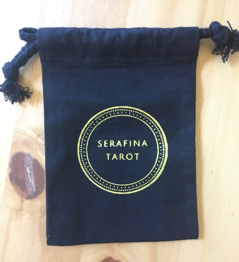 May include: Black drawstring bag with a gold circle logo that says "SERAFINA TAROT".