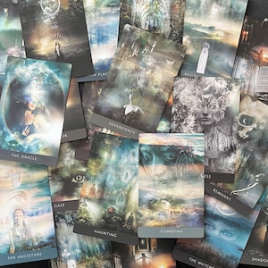 May include: A collection of rectangular oracle cards featuring surreal, atmospheric illustrations in muted tones. Each card displays a unique title at the bottom, including The Oracle, Sovereignty, Haunting, Guardian, The Ancestors, and Remnant.