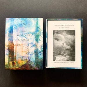 May include: A box set for the Wordless Oracle deck, featuring a blue and green watercolor-style image of trees and a full moon. The box includes a guidebook with a black and white photo of a person walking on a beach with a cloudy sky.