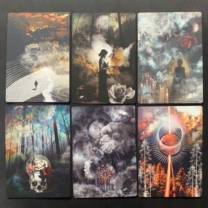 May include: A set of 6 tarot cards with various imagery, including a woman in a forest, a skull with a rose, a moon in the clouds, and a red orb in the sky.