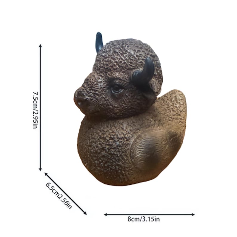 A brown bison figurine with black horns and a textured surface. The figurine measures 3.15 inches wide, 2.56 inches deep, and 2.95 inches tall. The bison is in a duck-like pose, with a detailed face and body.
