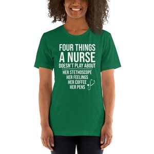 May include: Green t-shirt with white text that reads "Four things a nurse doesn't play about: her stethoscope, her feelings, her coffee, her pens". A white stethoscope icon is next to the text.