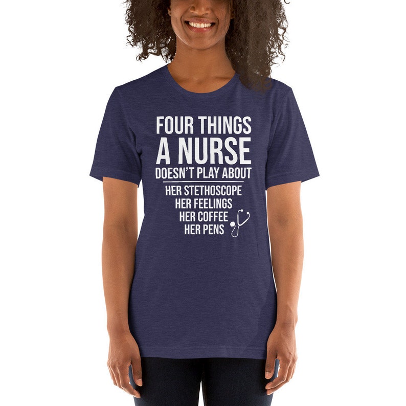 May include: A navy blue t-shirt with white text that reads "Four things a nurse doesn't play about: her stethoscope, her feelings, her coffee, her pens". A white stethoscope icon is next to the text.