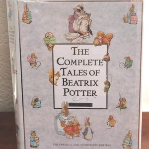 May include: A hardcover book titled The Complete Tales of Beatrix Potter with a light gray cover featuring illustrations of various animal characters including rabbits, squirrels, and kittens. The text The Original and Authorized Edition is printed.