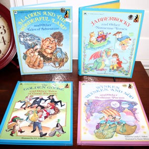 May include: Four vintage children's books with colorful illustrations. Titles include "Aladdin and the Wonderful Lamp", "Jabberwocky", "The Golden Goose", and "Wynken, Blynken, and Nod". Each book has a blue or pink border and features classic storybook art.