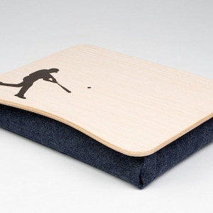 May include: A wooden tray with a silhouette of a baseball player on it. The tray is sitting on a blue fabric cushion. The cushion has a label that says "TRAY" on it.