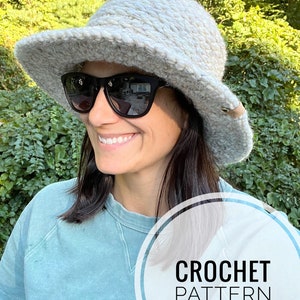 May include: Crochet pattern for a winter brim beanie. The pattern is called "JJ's Winter Brim Beanie". The image shows a woman wearing a white beanie with a wide brim.