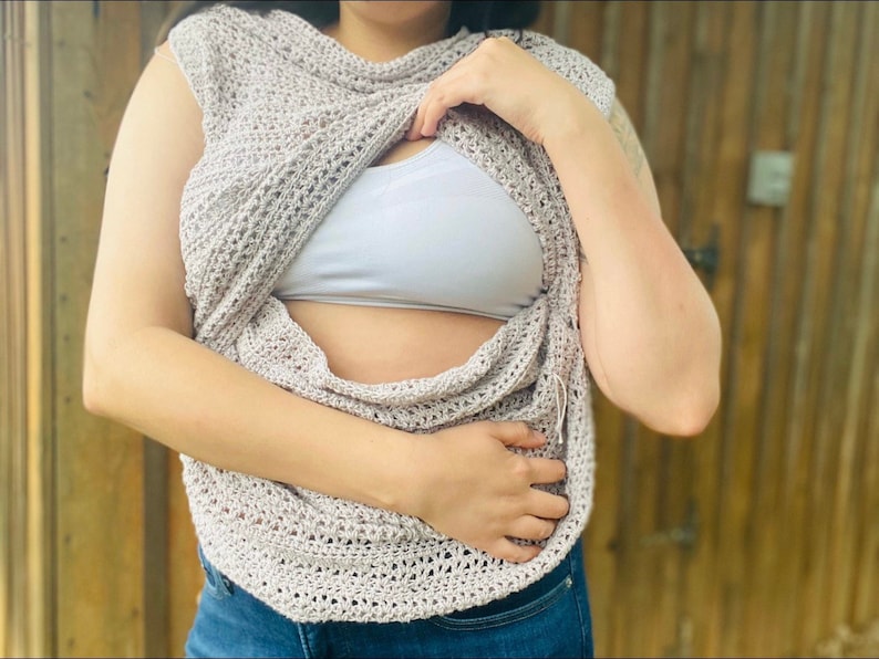 May include: A light brown crochet top with a loose, open weave. The top is worn over a white tank top.