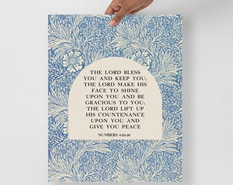 May include: A rectangular wall art print featuring a blue and cream floral botanical pattern. Centered is a cream-coloured arch containing the black text: THE LORD BLESS YOU AND KEEP YOU; THE LORD MAKE HIS FACE TO SHINE UPON YOU AND BE GRACIOUS TO YOU; THE LORD LIFT UP HIS COUNTENANCE UPON YOU AND GIVE YOU PEACE NUMBERS 6:24-26.