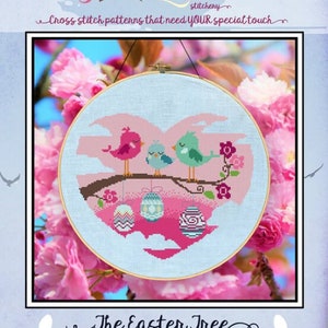 May include: Cross stitch pattern of a heart-shaped Easter tree with three birds and hanging eggs. The pattern is in a hoop and surrounded by pink cherry blossoms.