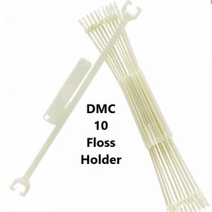 May include: White plastic floss holder with 10 slots. The holder is labeled "DMC 10 Floss Holder".
