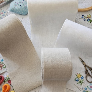 May include: A set of three ceramic mugs with a speckled, matte finish in cream, light grey, and dark grey. Each mug has a minimalist design, ideal for coffee or tea.