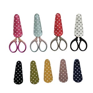 May include: A selection of small scissors with decorative covers. The scissors have different handle colours, such as pink, silver, and black. The covers are polka-dotted in red, blue, and white. Additional covers in various colours are also shown.