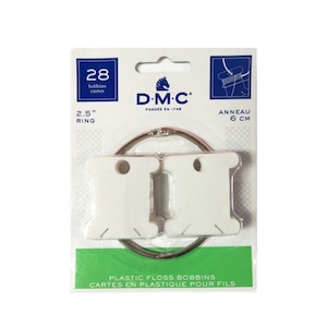 May include: Two white plastic floss bobbins with a 2.5 inch ring, packaged with a DMC logo and the text "28 bobbins cartes" and "Anneau 6 cm".