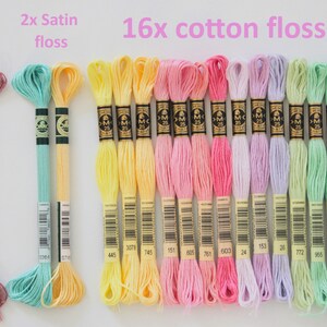 May include: A collection of embroidery floss in various colors, including pink, yellow, blue, and green. The image shows 2 skeins of light effects floss, 2 satin floss skeins, and 16 cotton floss skeins. Text on the image reads "16x cotton floss."