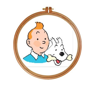 May include: A cross-stitch embroidery hoop featuring a cartoon image of a boy with red hair and a white dog. The boy is wearing a blue shirt and the dog is holding a bone in its mouth.