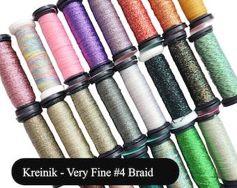 May include: A collection of spools of Kreinik Very Fine #4 Braid embroidery floss in various colors, including gold, silver, green, and pink.
