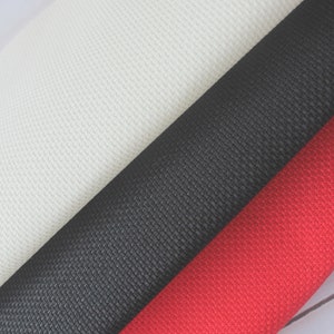 May include: Three fabric swatches in different colors: white, black, and red. The fabric has a textured weave.