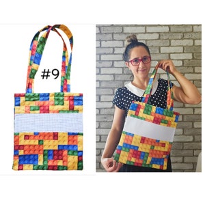 May include: A colorful tote bag with a Lego brick pattern. The bag has a white stripe across the middle and the number "#9" printed on the front.