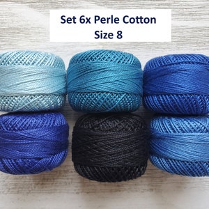 May include: A set of six balls of Perle cotton thread in size 8, arranged in two rows of three. The colours include light blue, teal, royal blue, dark blue, black, and medium blue. The text "Set 6x Perle Cotton Size 8" is visible at the top.