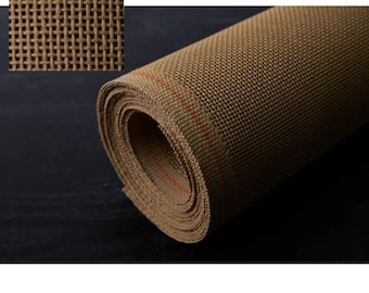 May include: A roll of brown mesh fabric with a woven texture. The fabric is rolled up tightly and has a red thread running along the edge.