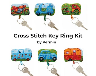 May include: Cross Stitch Key Ring Kit by Permin. Six different keychains featuring colorful cross-stitch designs of vehicles, including a motorcycle, scooter, bicycle, car, van, and camper.