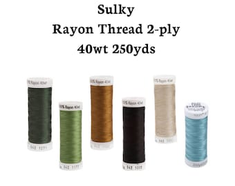 May include: Six spools of Sulky Rayon Thread 2-ply 40wt 250yds in various colours: green, olive green, brown, black, beige, and blue.