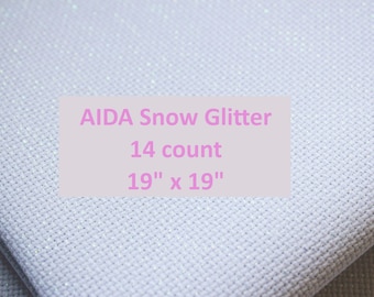 May include: White Aida cloth with a subtle sparkle, labeled "AIDA Snow Glitter 14 count 19" x 19"