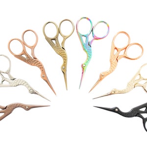 May include: A set of ten decorative scissors with bird-shaped handles. The scissors are in various colours, including gold, silver, black, and rainbow.