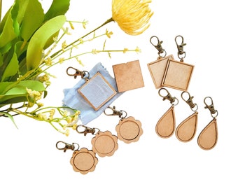 May include: A set of eight wooden keychains with different shapes, including circles, squares, and teardrops. The keychains are all unfinished and ready to be painted or decorated.