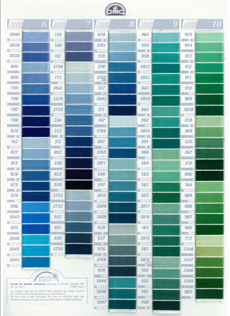 May include: DMC embroidery floss color chart with a range of blues and greens. Each color is numbered and displayed in a vertical column. The chart includes a DMC logo and text indicating the thread's compliance with safety standards.