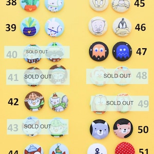 a collection of colorful buttons with various designs, including animals, cartoon characters, and other decorative elements.