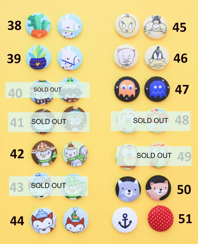 a collection of colorful buttons with various designs, including animals, cartoon characters, and other decorative elements.
