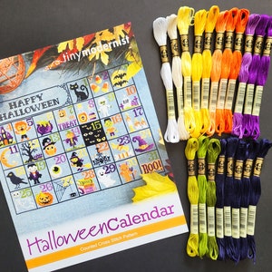 Peut inclure: Un kit de point de croix avec un calendrier d'Halloween repr&eacute;sentant divers personnages et symboles effrayants. Le kit comprend un motif imprim&eacute; et une vari&eacute;t&eacute; de fils &agrave; broder de couleurs.