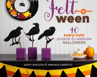 May include: A book titled "Felt-ween" with a purple, orange, and black color scheme. The book cover features a felt wreath with a spider and a variety of fall leaves. The book title is written in a whimsical font. The book cover also includes the text "40 scary-cute projects to celebrate HALLOWEEN".
