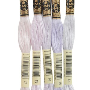 four skeins of white and purple yarn