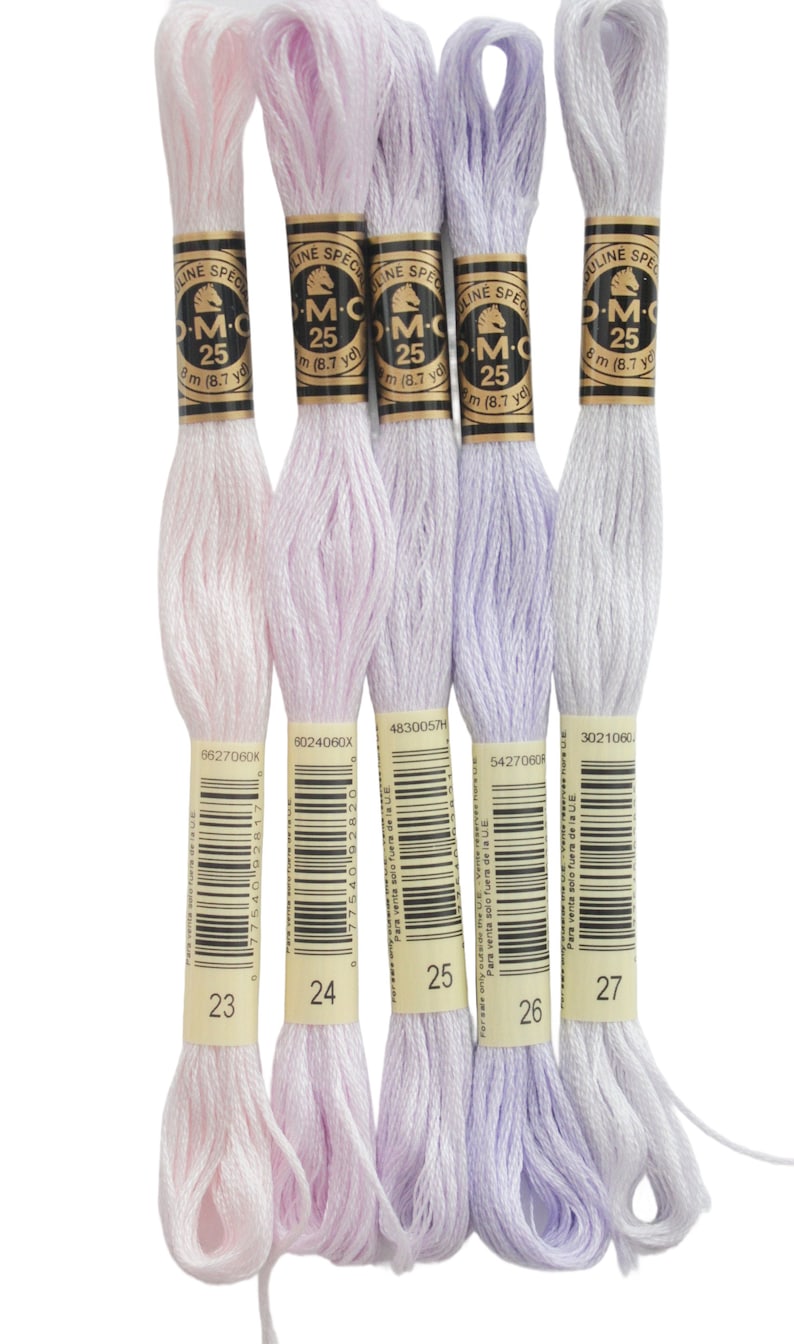 four skeins of white and purple yarn