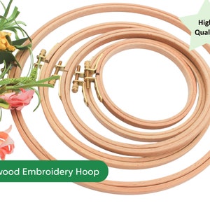 May include: Set of four wooden embroidery hoops, ranging in size. The hoops are made of natural beechwood and have a smooth, polished finish. The hoops are nested together, with the largest hoop at the bottom and the smallest hoop at the top. The hoops are held together by a brass screw mechanism. The text "Beechwood Embroidery Hoop" is visible at the bottom of the image. A green star with the text "High Quality" is visible in the top right corner of the image.