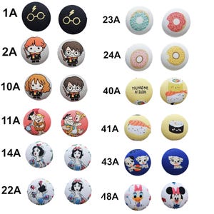a collection of 16 different buttons, each with unique designs and characters printed on them. The buttons are arranged in a grid with 4 rows and 4 columns, showcasing a variety of styles and themes.