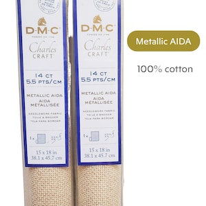 Pode incluir: Dois rolos de tecido AIDA met&aacute;lico para bordar, 38,1 x 45,7 cm, 14 count, 5,5 pontos/cm. A embalagem apresenta o texto "DMC Charles Craft" e "AIDA met&aacute;lico 100% algod&atilde;o".