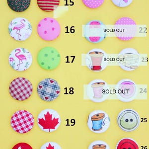 a collection of colorful buttons with various designs, including polka dots, stripes, and other patterns.