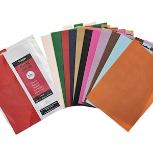 May include: A collection of 14-mesh plastic canvas sheets in various colors, including red, green, blue, and orange. A package of red canvas is visible on the left. The sheets are 8.5" x 11" (21.6cm x 27.9cm).