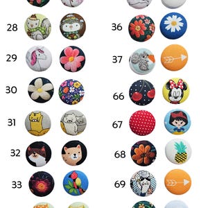 a number of different colored buttons on a white surface
