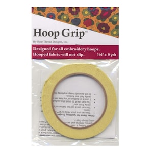 May include: A package of Hoop Grip, designed for embroidery hoops. The package features a roll of yellow fabric tape, approximately 0.6 cm by 8.2 metres, to prevent fabric slippage. The packaging includes the text "Hoop Grip" and "Designed for all embroidery hoops."