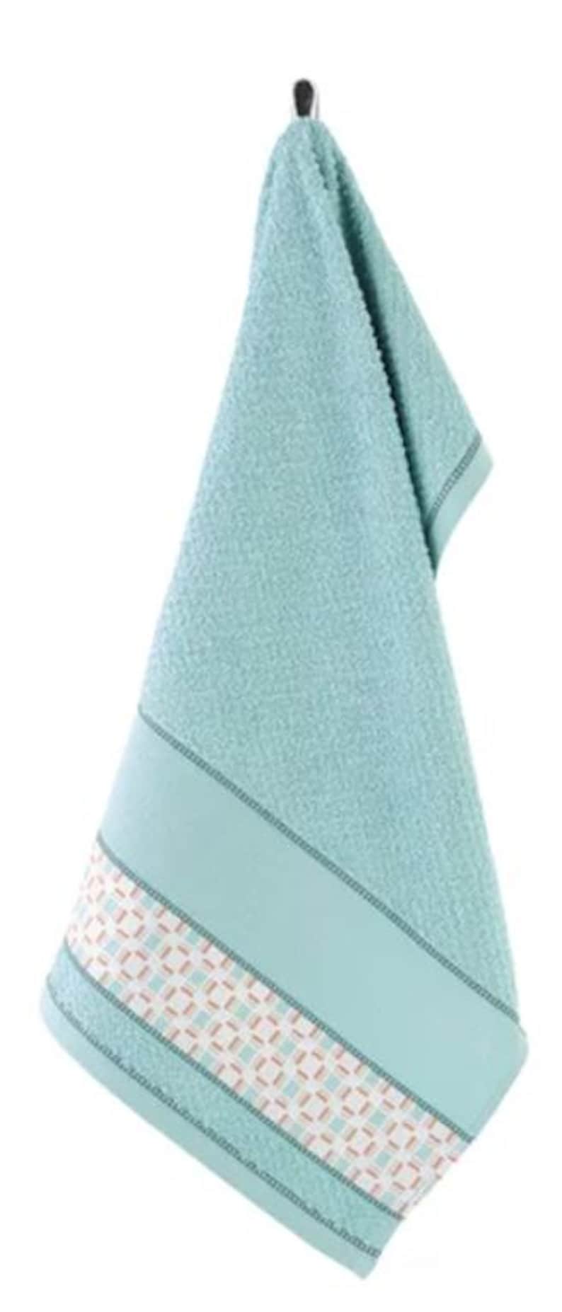 May include: A light blue hand towel hanging from a metal hook. The towel has a textured surface and a decorative band at the bottom with a geometric pattern in white, brown, and light blue. The towel is made of a soft material.