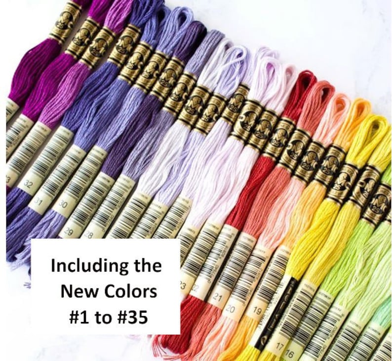 May include: A collection of embroidery floss in a variety of colors, including shades of purple, red, yellow, and green. The image includes the text "Including the New Colors #1 to #35". Each skein is labeled with a number.