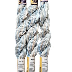 three skeins of yarn sitting on top of each other